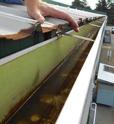 Leaking gutter being repaired on a Baltimore County home