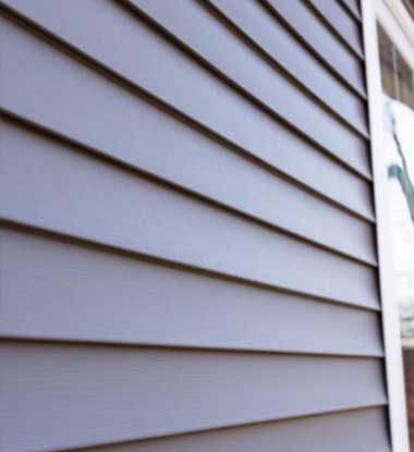 Close up of new vinyl siding panels on an Anne Arundel County property